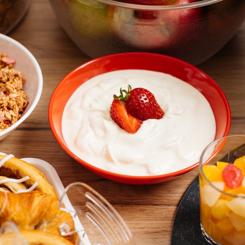 Red Plastic Bowl with Yogurt