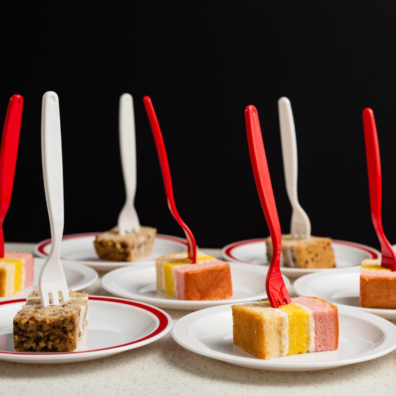 Red and white forks with cake slices