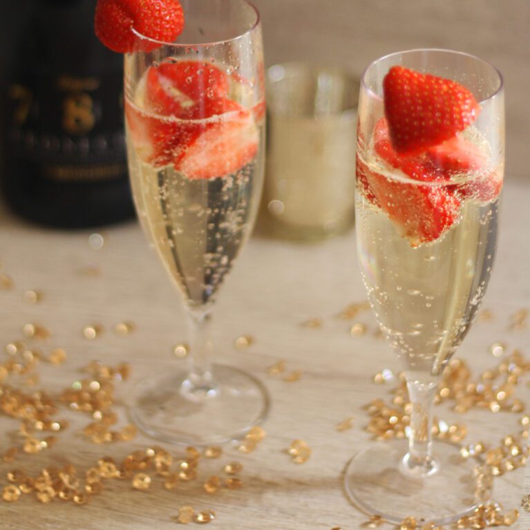 Plastic Champagne Flute with prosecco and strawberries