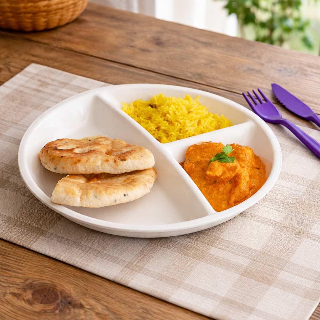 3 section white plate with curry in home setting