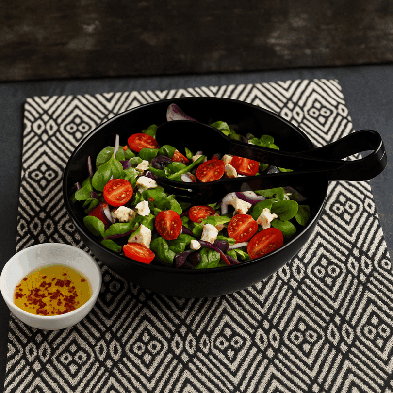 Black Salad with Tongs In Use