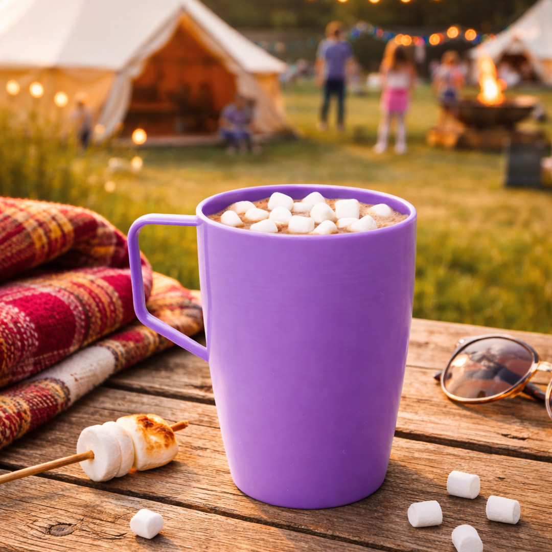 purple outdoor cup with handle in camping setting with hot chocolate